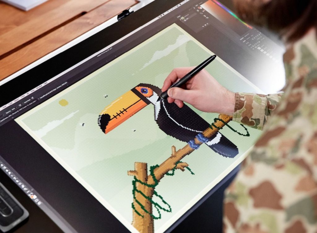 Hombre dibujando pixel art sobre tablet grafica